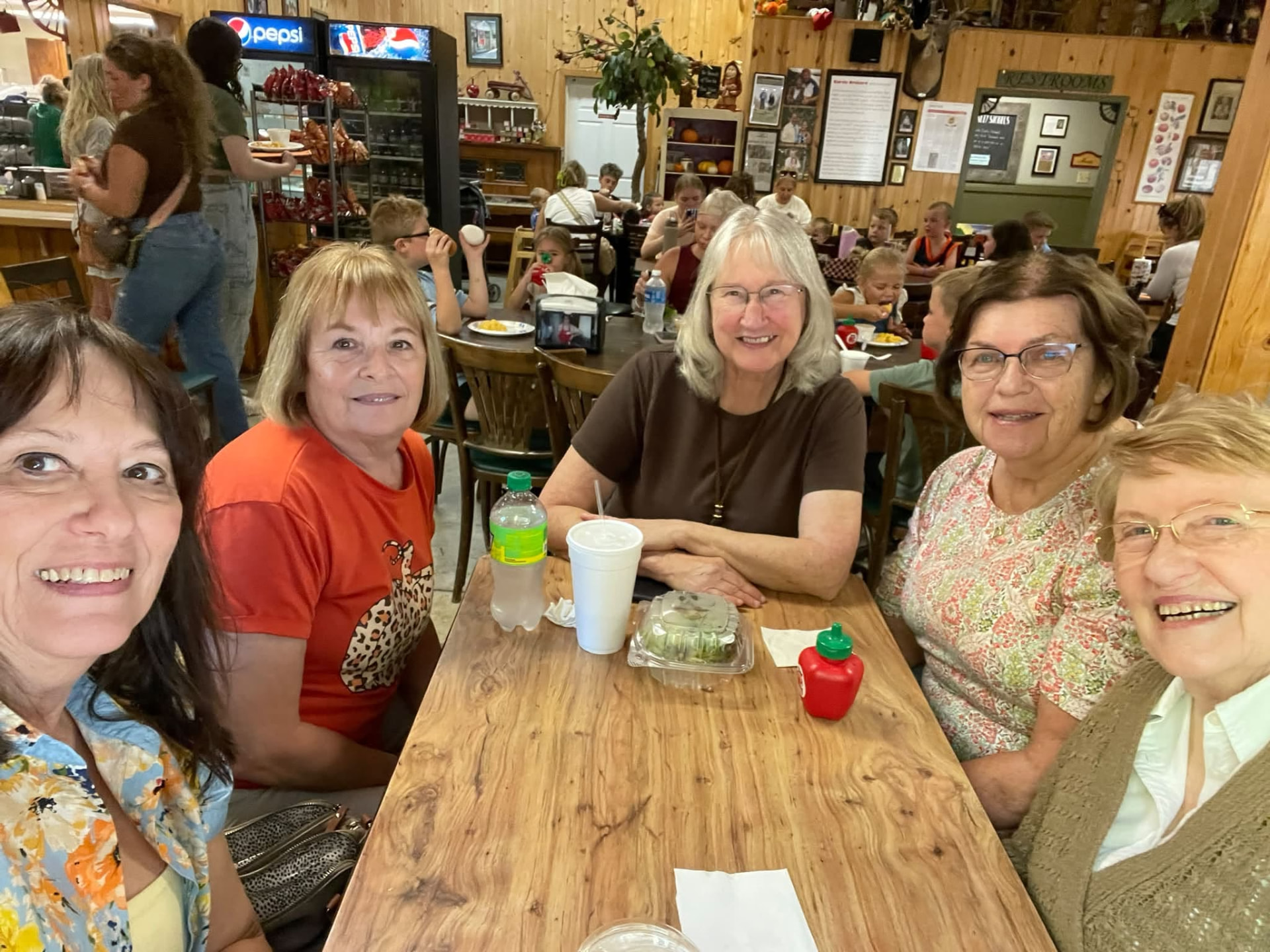 Xi Chapter members sharing lunch together at a table at Curtis Orchard