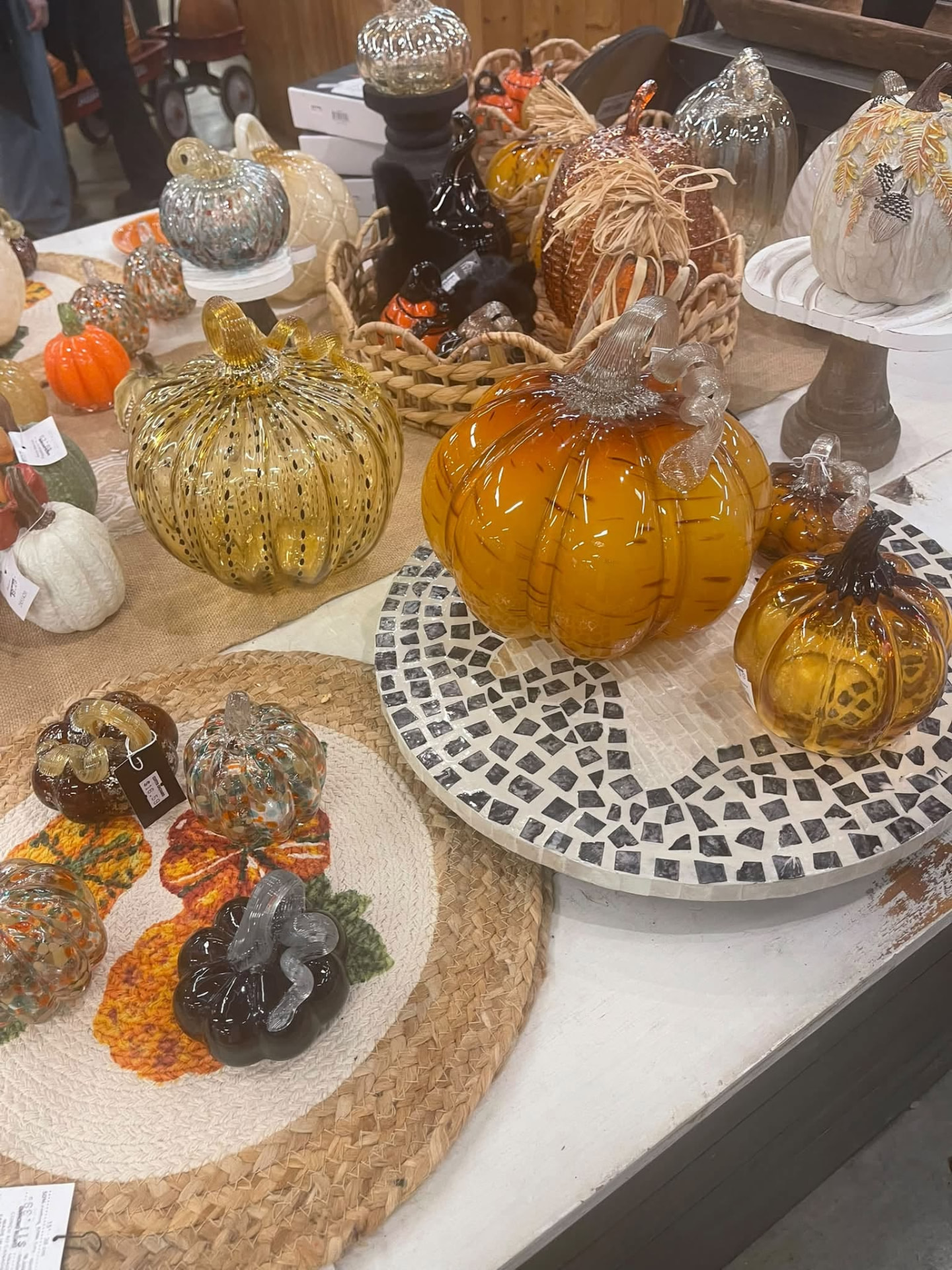 Hand-blown glass pumpkins in autumn colors on display at Curtis Orchard